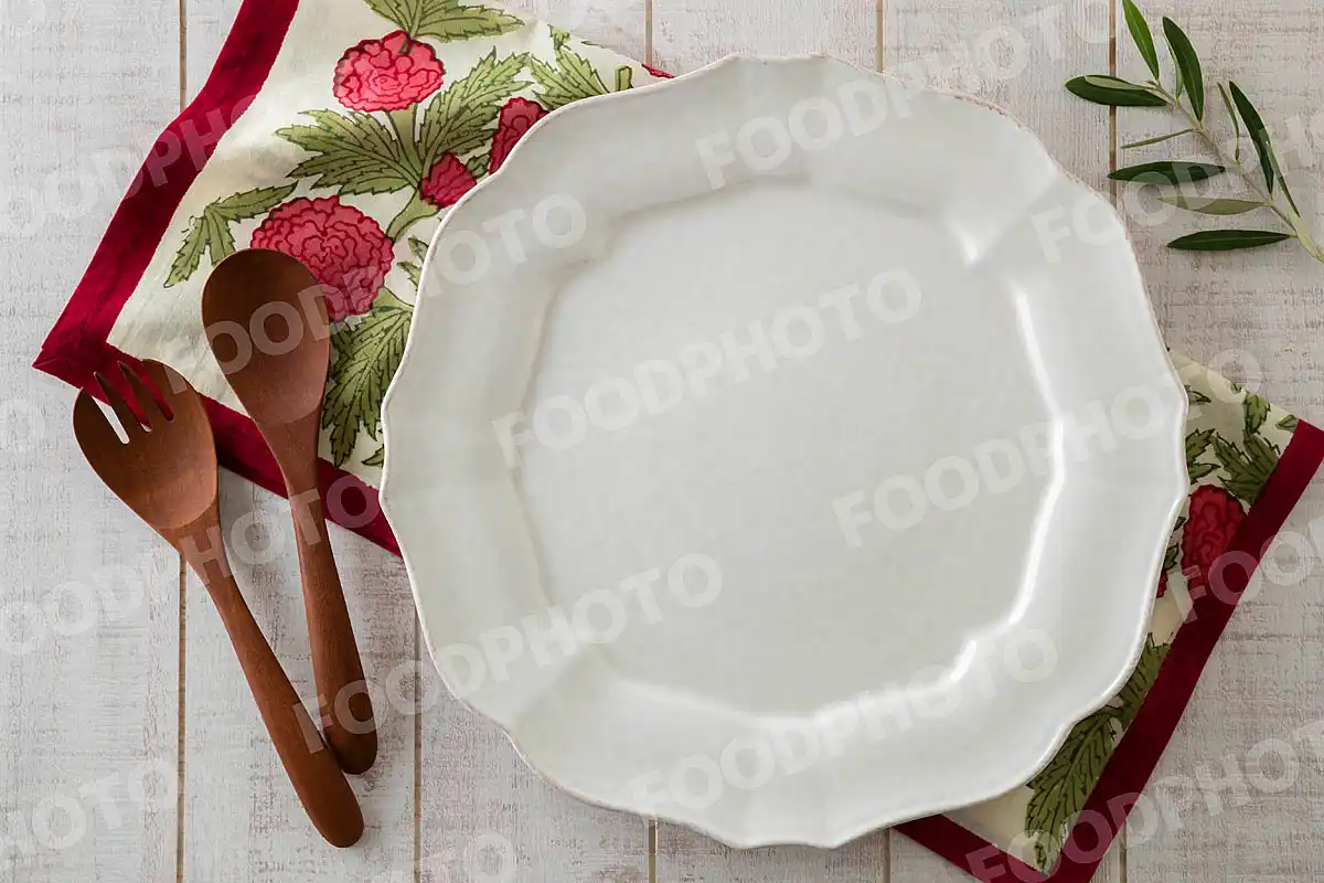 木製カトラリーとアンティークなリムのデザインのディナープレート