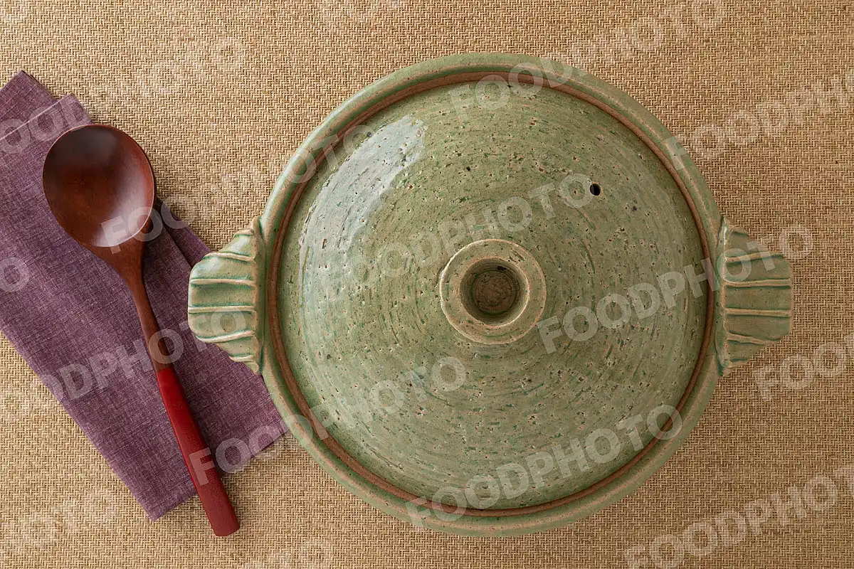 木製のおたまと透明感のある浅緑の土鍋 / 蓋閉